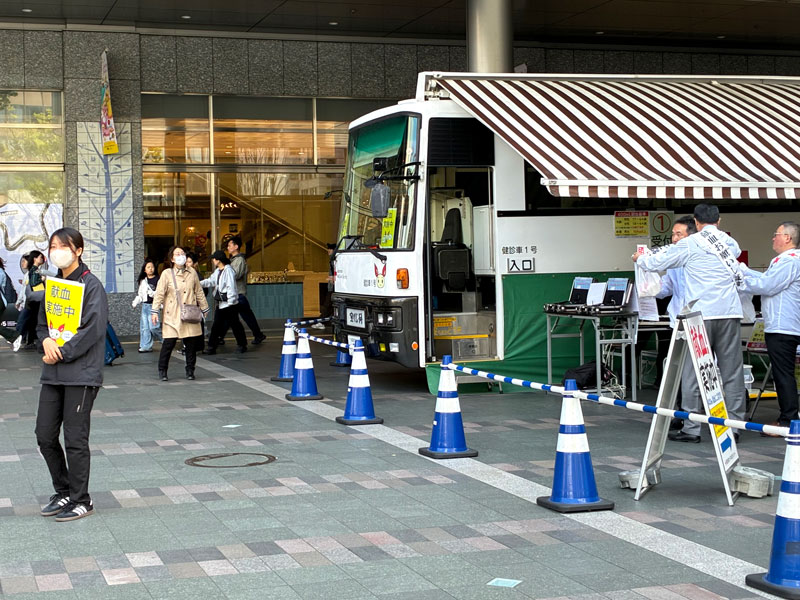 献血車と献血を呼び掛けるライオンズの会員