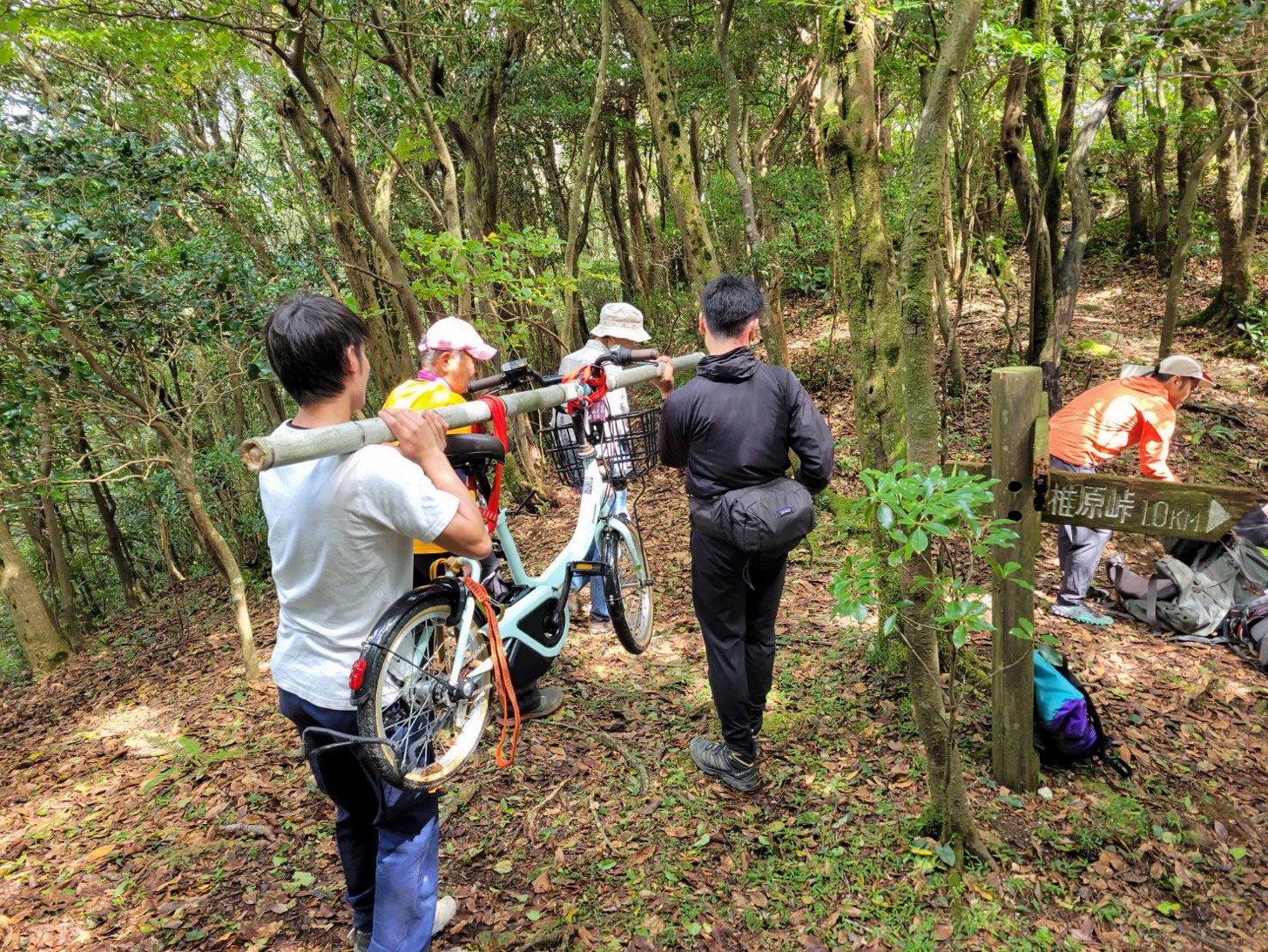 縦走路に放置された自転車を肩に担いで撤去　担いでいるのは早良区役所職員